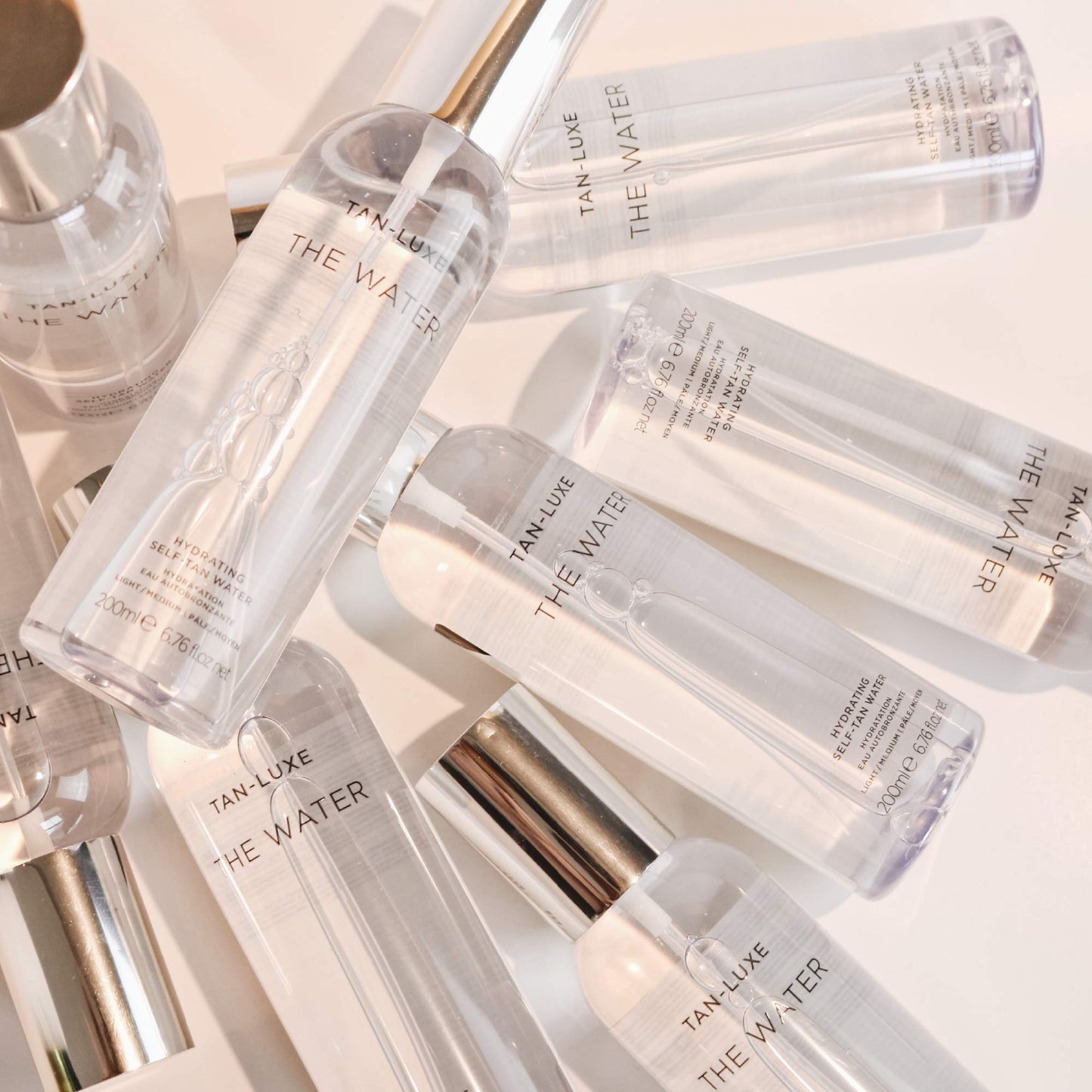 Tan-Luxe The Water Hydrating Self-Tan Water, Transparent Tanning Mist, Vitamin-Infused Tanner, Quick-Drying, Streak-Free, Vegan, No Fake Tan Smell, 6.76 fl. oz/200 ml Bottle (Medium/Dark)